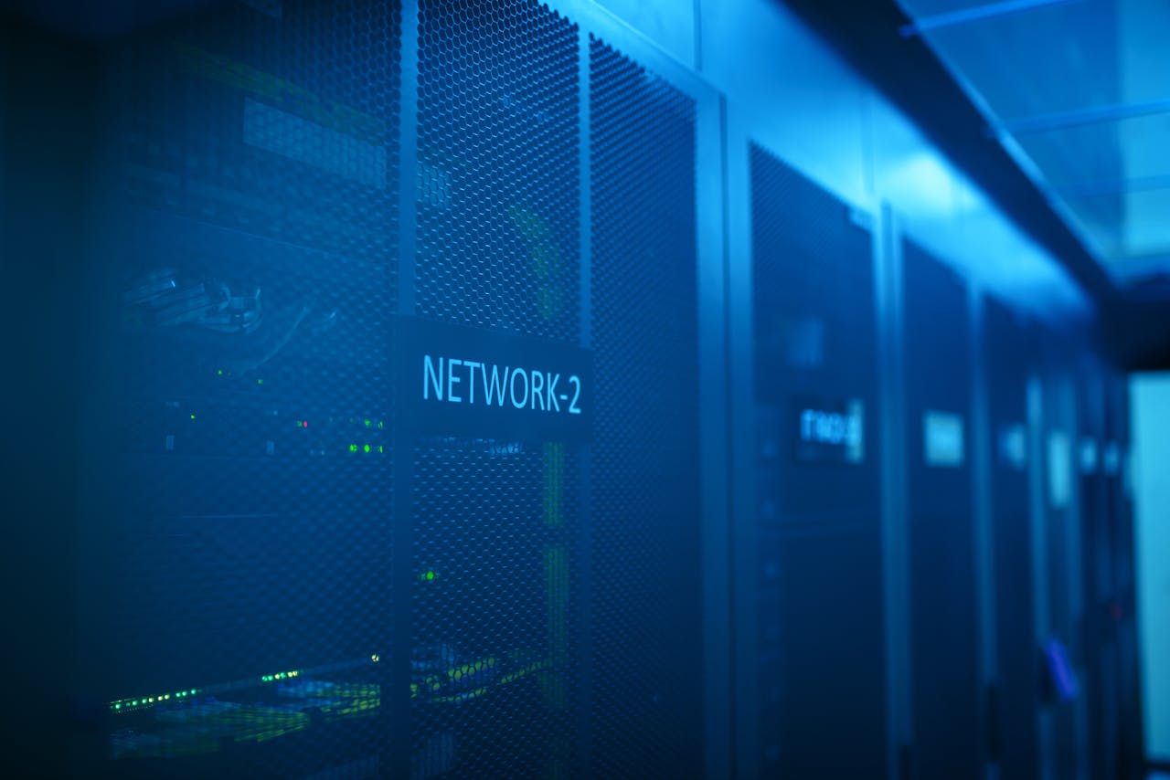 who-we-are A modern server room featuring network equipment with blue illumination. Ideal for technology themes.